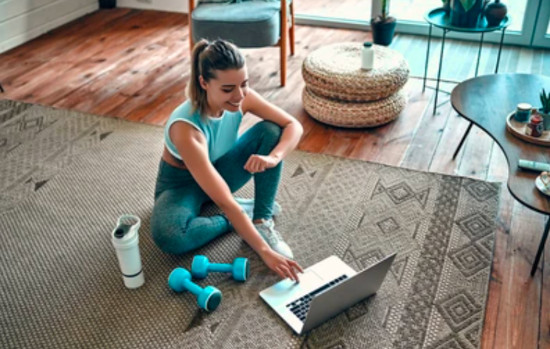 A woman using reverse phone lookup on a laptop